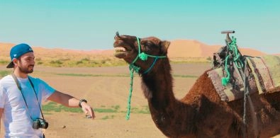 a picture of a guy with a camel in Ergchebbi Merzouga