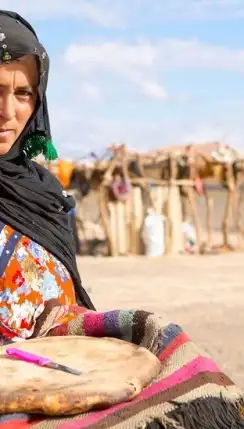 A women hold a berber pizza in Merzouga Morocco