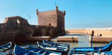 Traditional blue fishing boats docked at the port of Essaouira, Morocco.