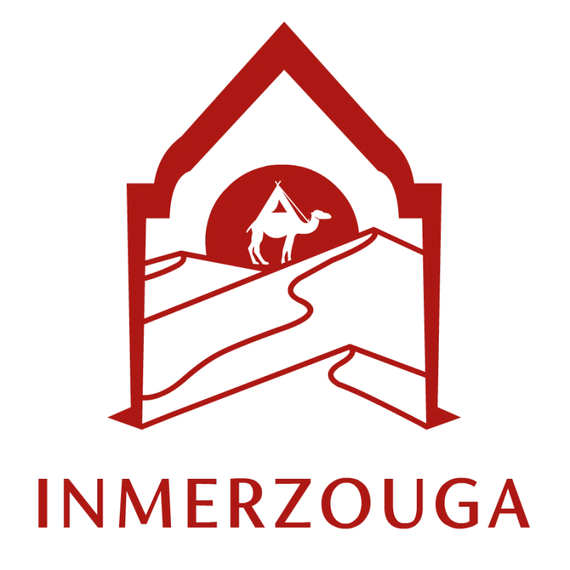 In Merzouga logo featuring a camel, Erg Chebbi dunes and a Moroccan-style arch.